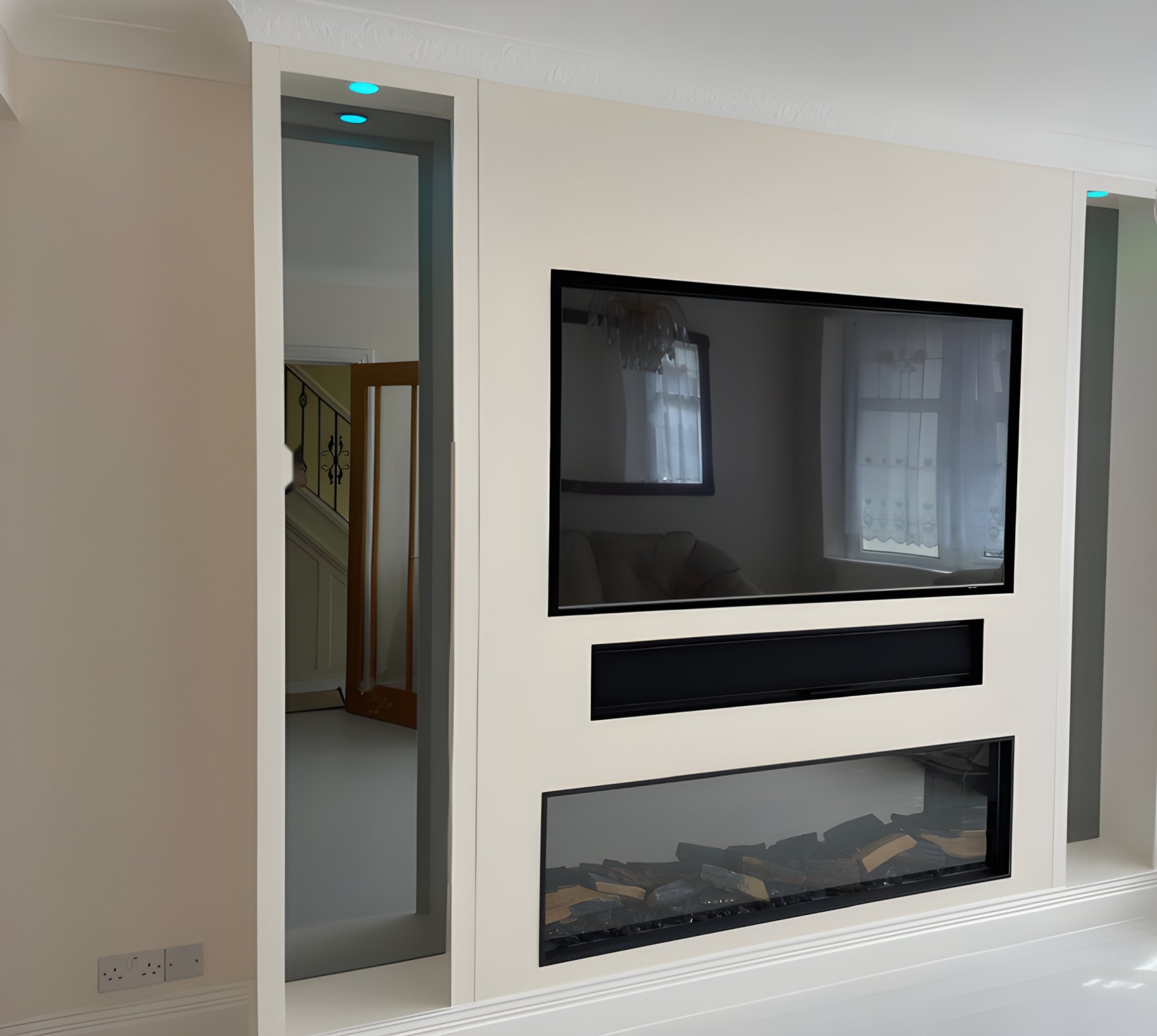 Cream media wall with recessed TV, soundbar and electric fire, with lit side recesses